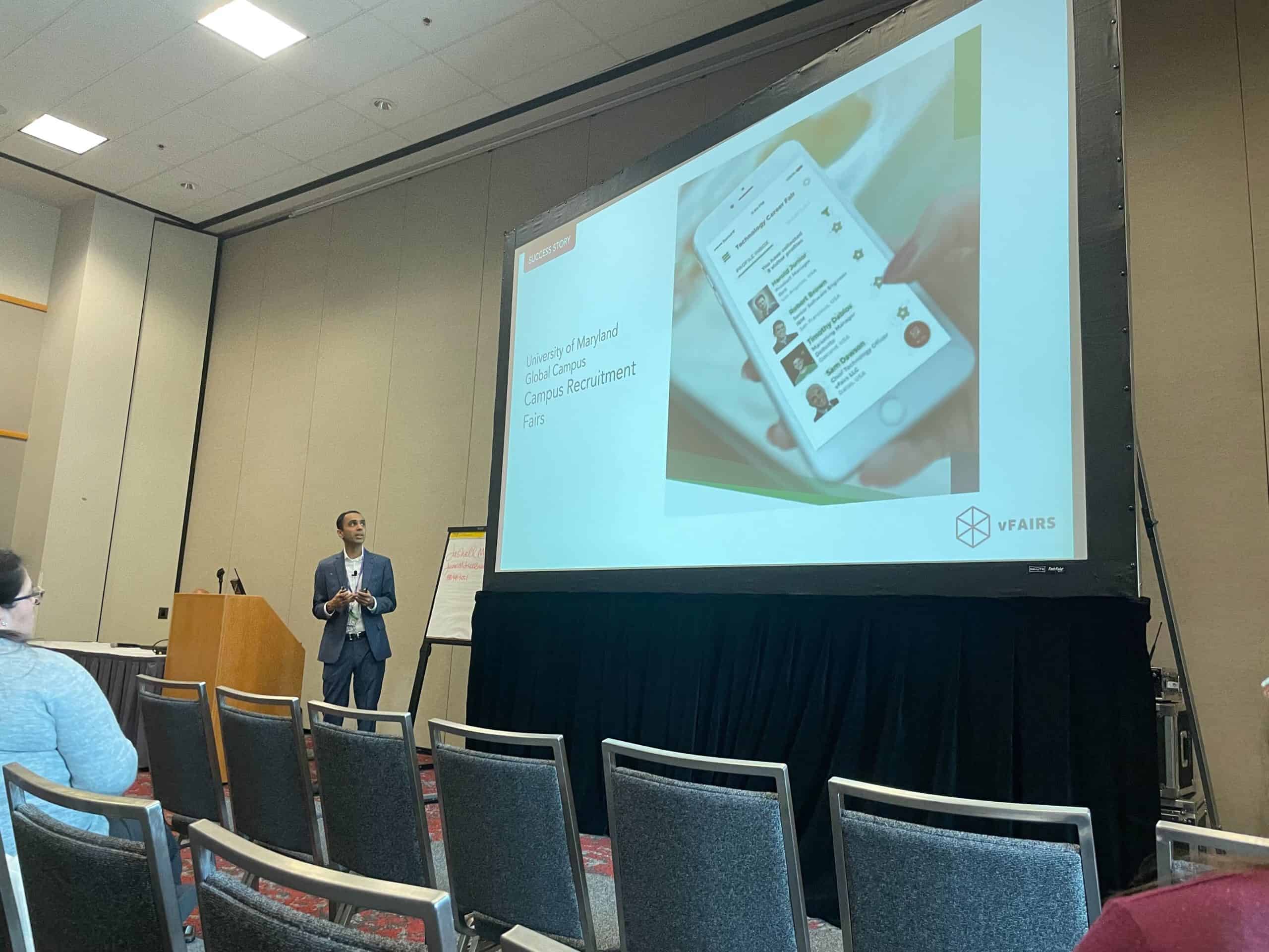 Speaker presenting at an in-person event.